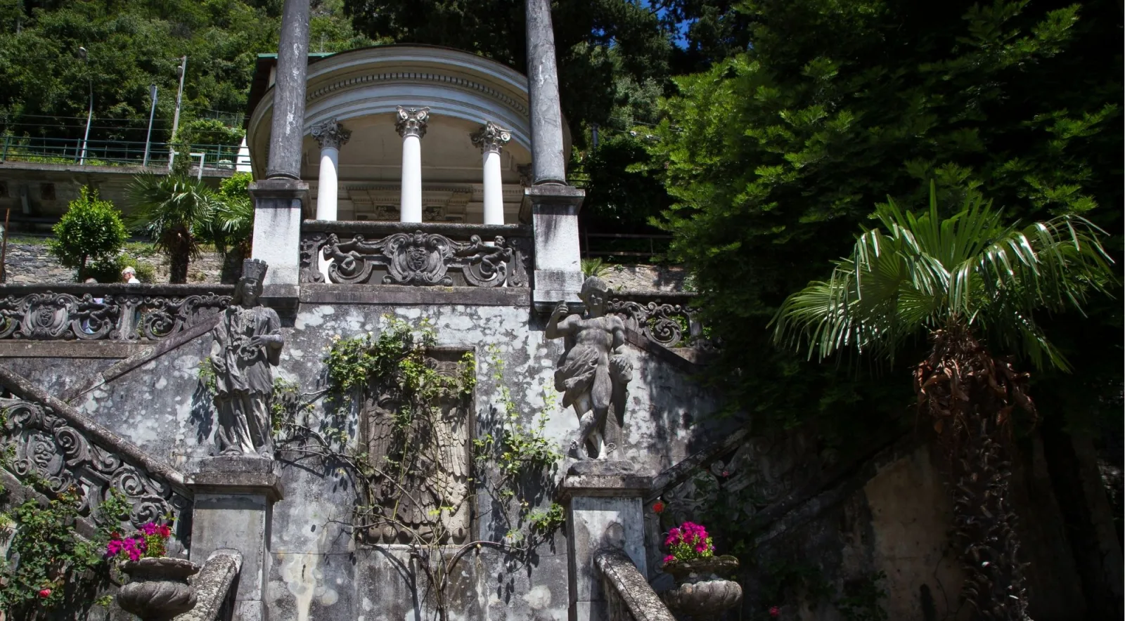Ornamental staircase with statues leading up to the columned tempietto in the Villa Monastero garden