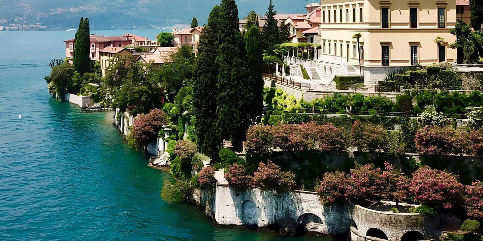 The Varenna shoreline from the water, Villa Cipressi's flowering terraces stepping down to the lake
