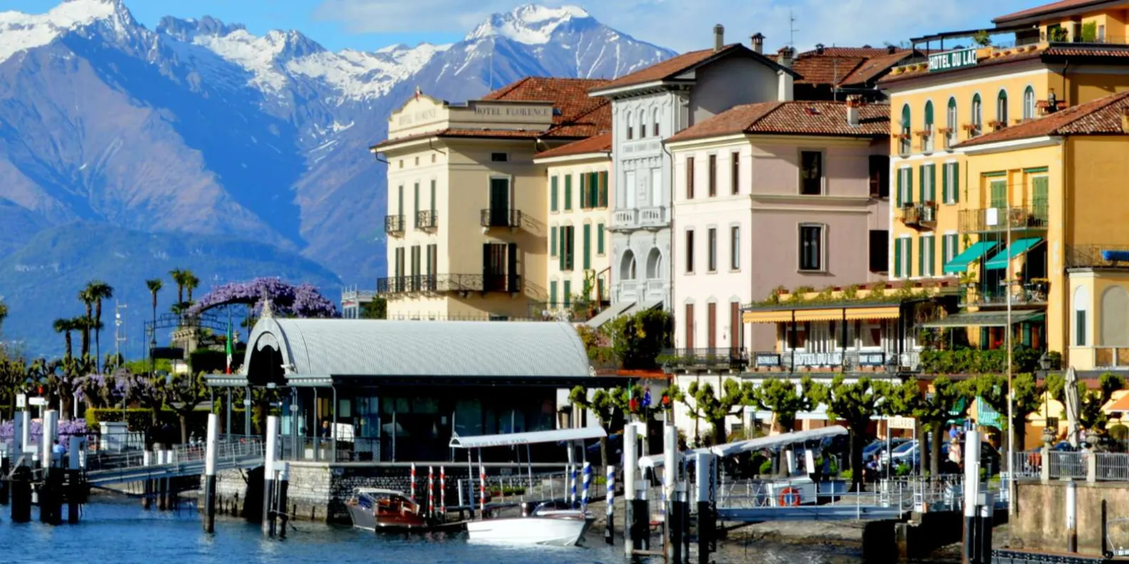 Bellagio's waterfront and ferry pier with the snow-topped Alps behind