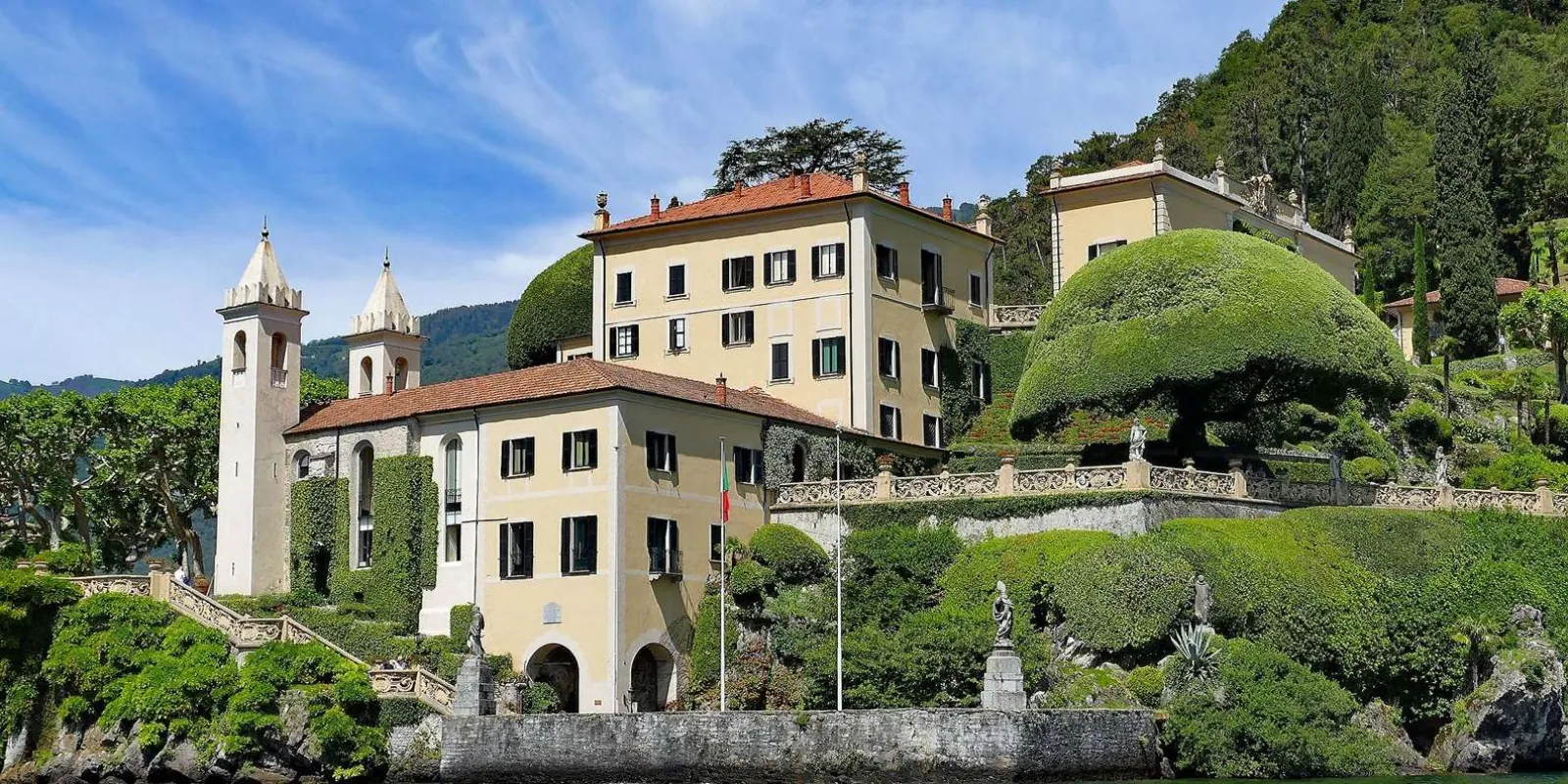 Villa del Balbianello on its wooded promontory, one of the villas the cruise passes